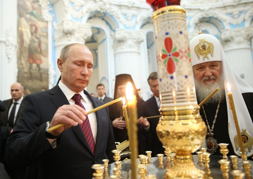 Putin, left, and Patriarch Kirill of Moscow light candles at the New Jerusalem Monastery in the town of Istra.