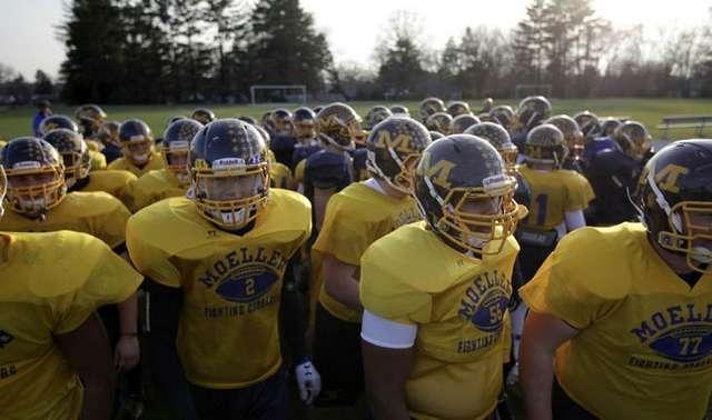 Some of the Archbishop Moeller High School Crusaders Football team gets ready for practice Tuesday, November 27.