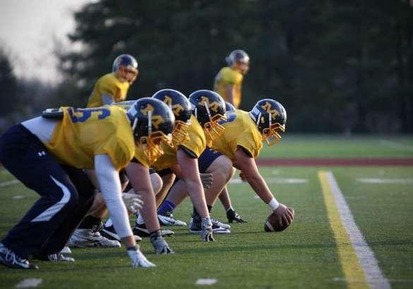 The Moeller Crusaders offensive line goes through drills at Archbishop Moeller High School, Tuesday, November 27.