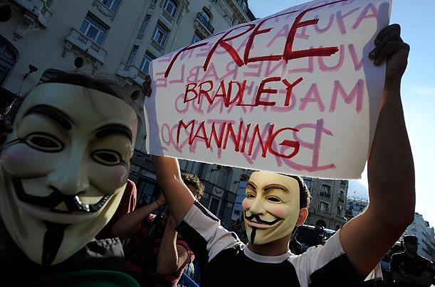 Protesters in Madrid wear Fawkes masks during a demonstration on July 24, 2011, as they demand the