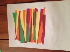 Cut around the thick black line of the cross Leave this to the side Cut up the coloured paper into strips Take the A5 piece of card Stick the strips of the colour paper onto the A5 white card Once