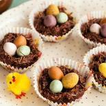 Work fast as chocolate hardens quickly Place an adequate amount of mixture into the bun case With spoon flatten centre slightly to allow eggs to sit without falling off Add eggs to nest Leave to set
