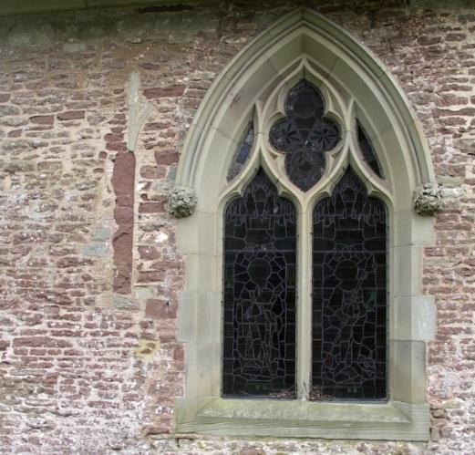 It is directly opposite the main entrance door to the church and is clearly old.