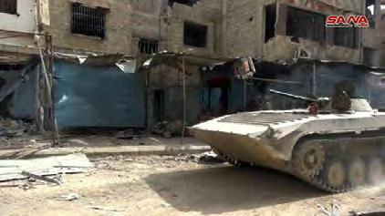 4 Right: Syrian army APC in the Al-Hajar al-aswad neighborhood (SANA, May 10, 2018).