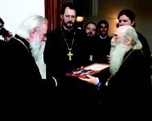 Chicago [Right] Metropolitan Vladimir presents Archbishop Job with panagia and pectoral cross set during
