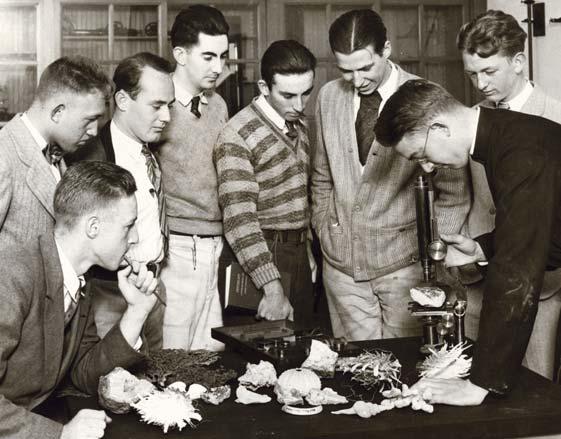 Science class at USF, circa 1927 Focusing a microscope, Joseph M. Clark, S.J., conducts a science class at the University of San Francisco.