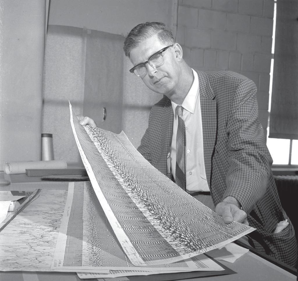 Dr. Kenneth L. Cook examining seismograms of the magnitude 9.2 Great Alaska Earthquake of March 27, 1964.