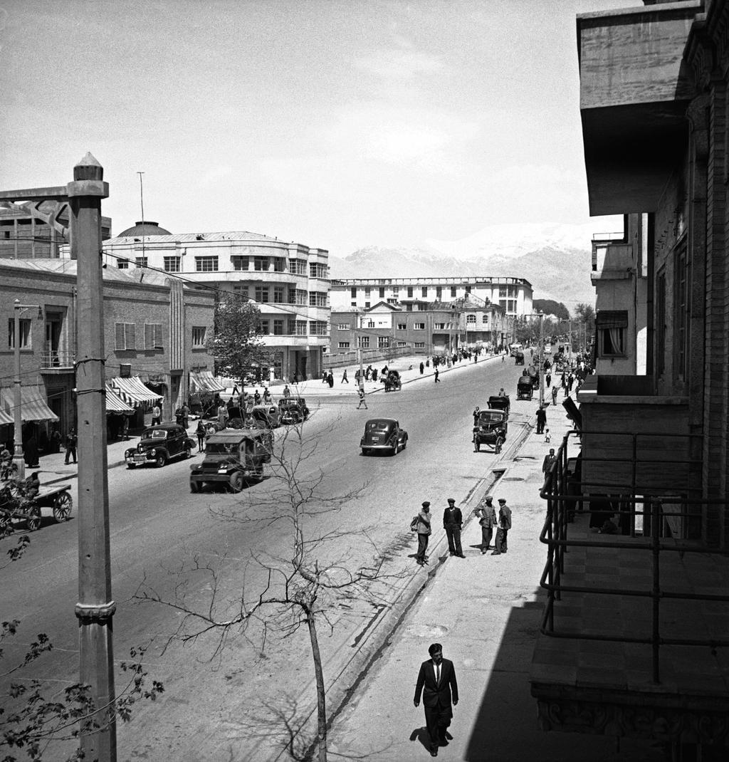 Cars and pedestrians travel on Ferdowsi Avenue in Tehran, Iran, April 20, 1946.