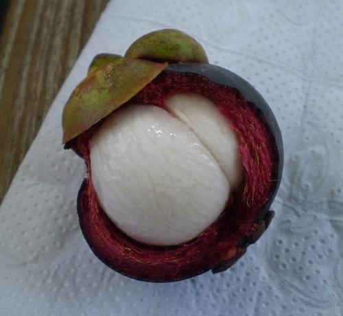 It is a tropical fruit that has purple outside shell with a white eatable fruit inside that is sweet and tangy with a texture similar to the peach.