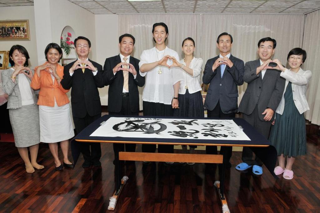 The long day concluded back at the headquarters church when HJN signed a calligraphy with the 12-gate UC symbol.