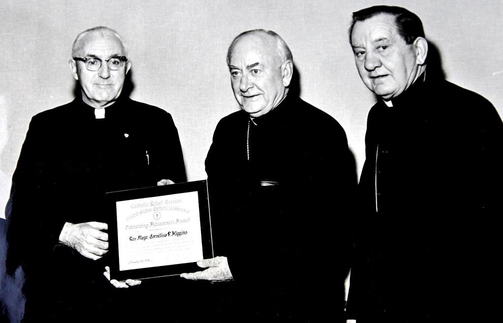 Photo from the Diocesan Archives Monsignor Higgins receives Catholic Relief Services Outstanding Achievement Award L-R, Monsignor Higgins, Archbishop Joseph McGucken and Bishop Edward Swanstrom,