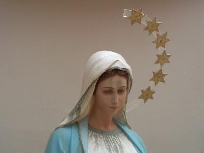 Statue of the Blessed Mother showing storm damage from