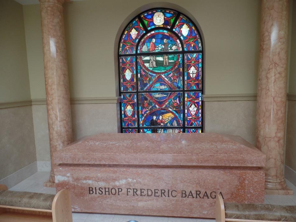 The south window, behind Baraga s sarcophagus, has a border of the eight crests of the dioceses where Baraga served. The crest at the top of the arch shows his Coat of Arms.