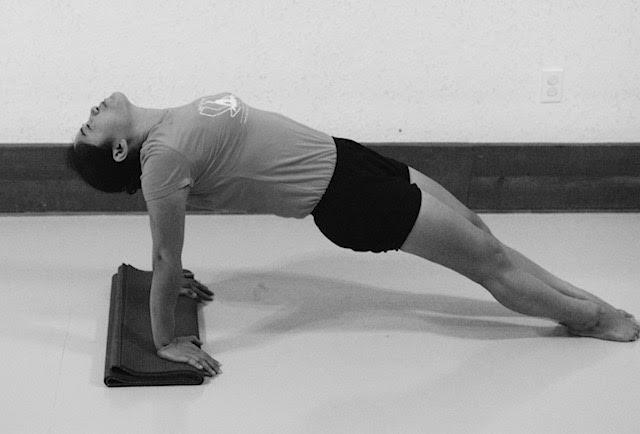 hands behind the outer hips. Roll the shoulders back and lift the chest.