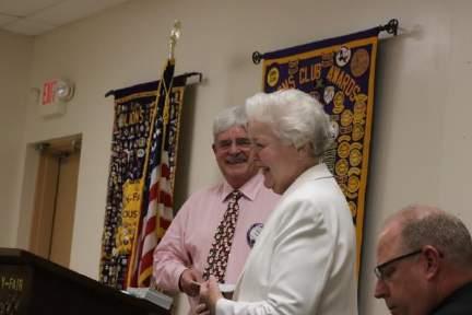 DG Betty presents Lion Bob with a Centennial Membership pin.