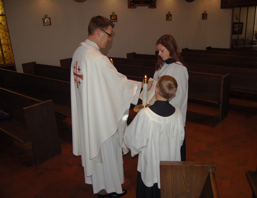 Figure 1: The priest or deacon will pick up the gospel, raising it