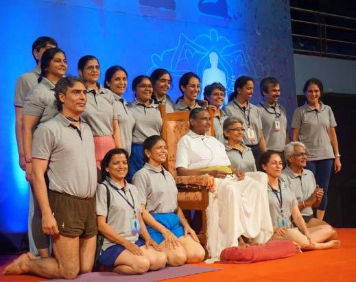 .. Geeta smiling, surrounded on stage by the next generation of Indian
