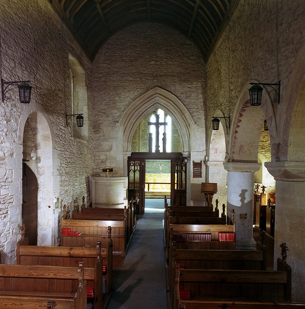 The nave has three arcades supported on stout Norman circular columns with square capitals and rounded arches, circa 1150; note the red painted Chevrons, from about 1150, in the arches.