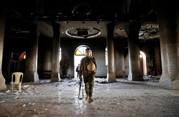 Ahmed Jadallah / Reuters An Iraqi Christian soldier attends the first Sunday mass at the Grand