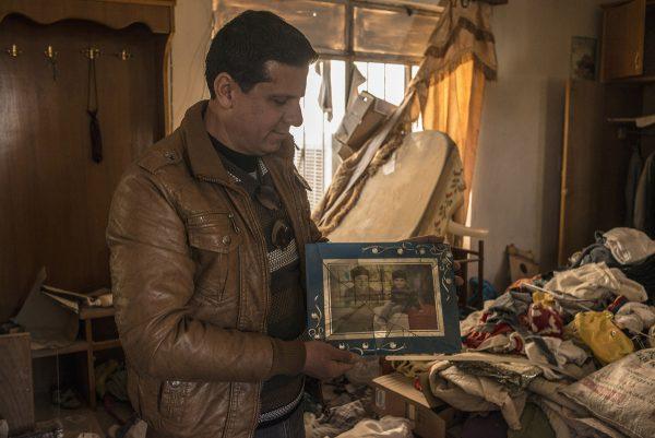 Martyn Aim / Corbis via Getty An Assyrian Christian artist who fled the Islamic State in 2014 from Qaraqosh, returns to his family home to begin sorting through his belongings that were ransacked for