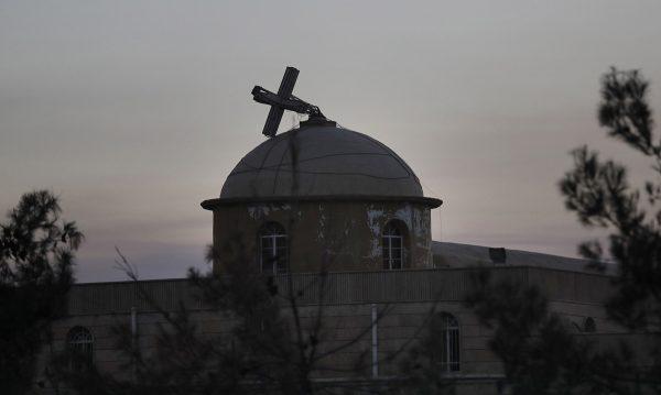 Thomas Coex / AFP / Getty The broken cross of a Christian Church in the town of
