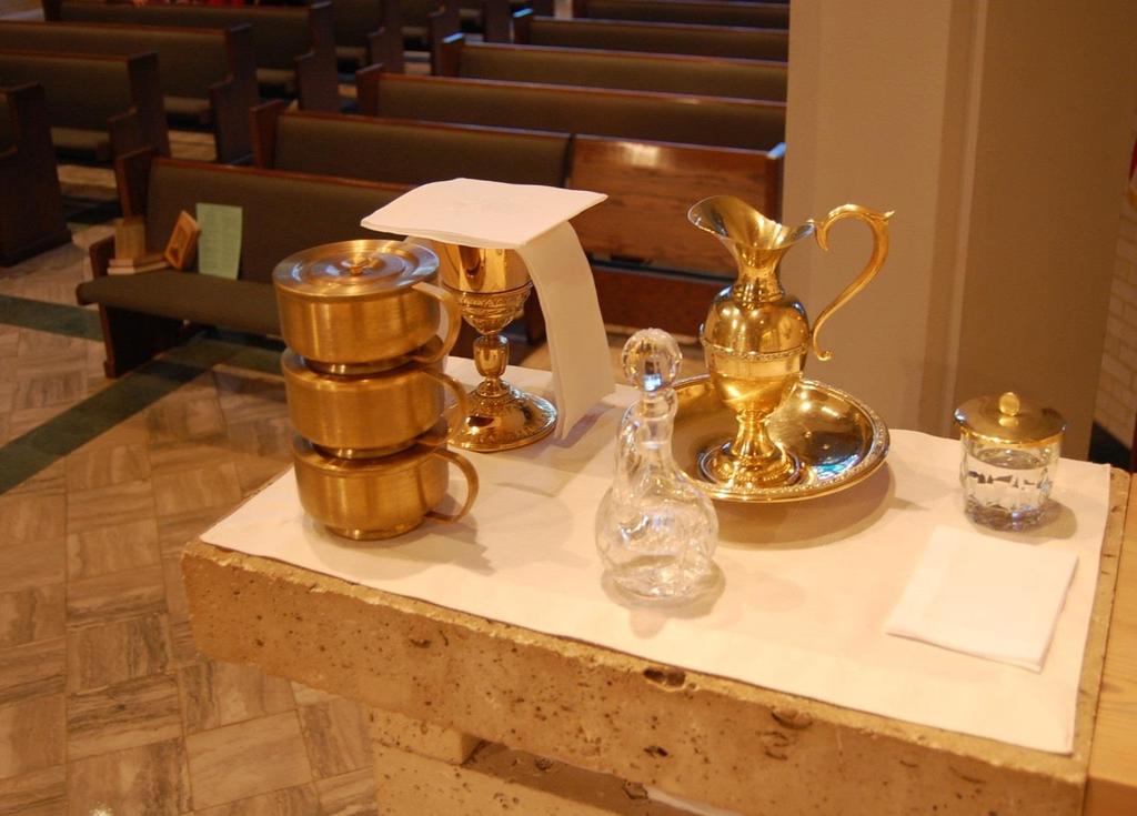 CREDENCE TABLE CARRY THE GOLD CHALICE, THE ROUND GOLD CIBORIA WITH LIDS AND THE GLASS WATER CRUET (NO TOP) TO