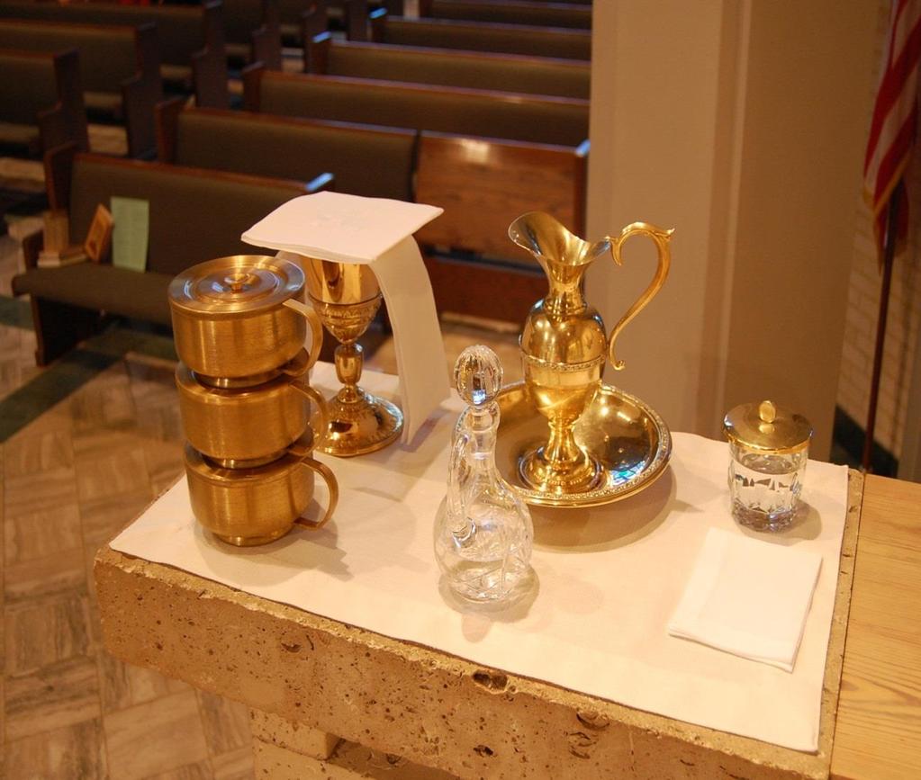 TYPICAL CREDENCE TABLE SETUP CHALICE WITH PALL AND PURIFICATOR, CIBORIA (3), WATER PITCHER WITH BOWL, WHITE PURIFICATOR (TOWEL), GLASS WATER CRUET WITH TOP, ABLUTION CUP