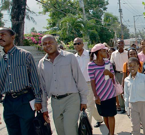 + A group of Haitian Jehovah s Witnesses heading out to bring comfort to the victims of the disaster % A doctor treating a boy at the clinic set up by Jehovah s Witnesses away.