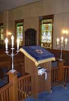 In Reform synagogues everyone sits together and the bimah is at the front, combined with the ark, rather than in the middle.