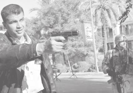 THE NEW LIGHT OF MYANMAR Sunday, 14 December, 2003 5 IRAQ UNDER US OCCUPATION An Iraqi policeman aims his handgun