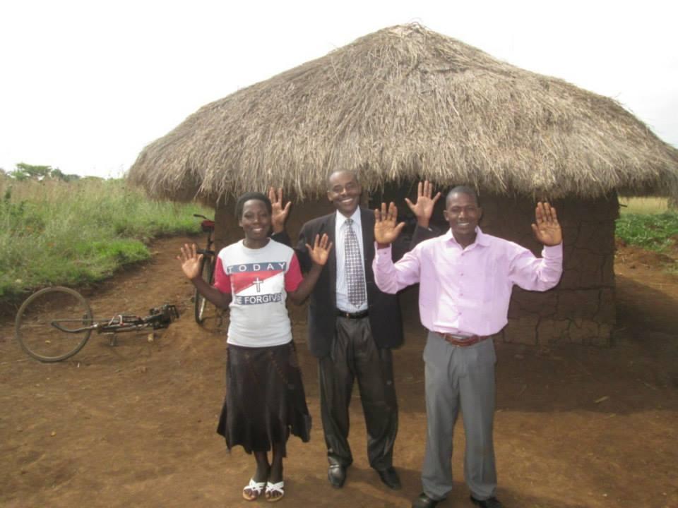 Pastor Erustus with Pastors Wycliffe and his wife Violet in front of the church