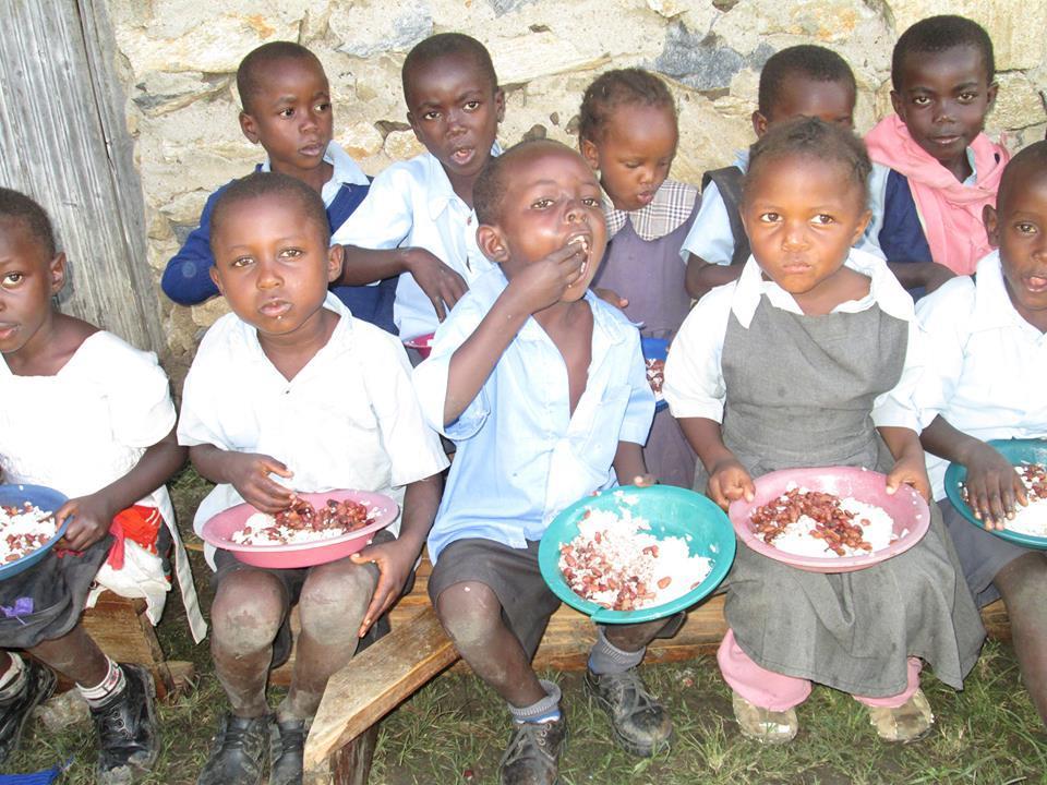 His ministry helps these children with food; School