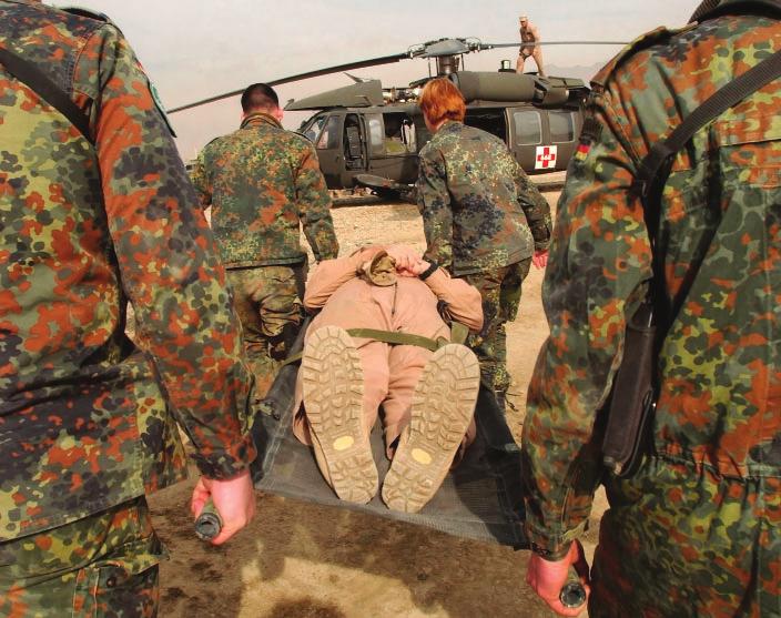 6 Question 5 Religion, War and Peace Look at the photograph below, which shows an injured man being rescued from the battlefi eld. 2 1 Name two organisations which help victims of war.