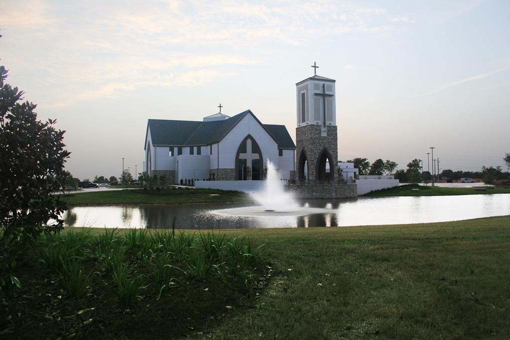 A-305.09 View of the church from across the reflecting pond with the Bell Tower in the foreground.
