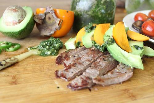 By Chef Zissie Spivak Serves: 4 Ingredients: 2 pounds minute steak 1/4 cup extra virgin olive oil 2 persimmon, sliced 2 avocados, sliced 1/2 cup fresh mint, finely chopped 1/2 cup fresh basil, finely
