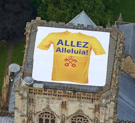 York Minster joined in the Tour De France by unveiling its own rooftop yellow jersey with Allez, Alleluia!
