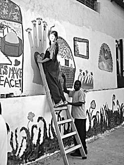 neighborhood. The participants and local youth worked together painting the walls in the community centers, making them more pleasant for children and young people.