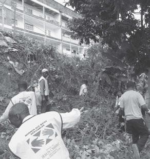 A Cameroon Yaounde Branch clears and cleans up debris around the city hall.