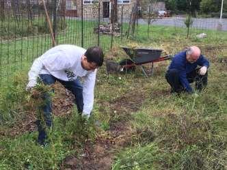 Josh and Bill work in the hospice garden Together representing a