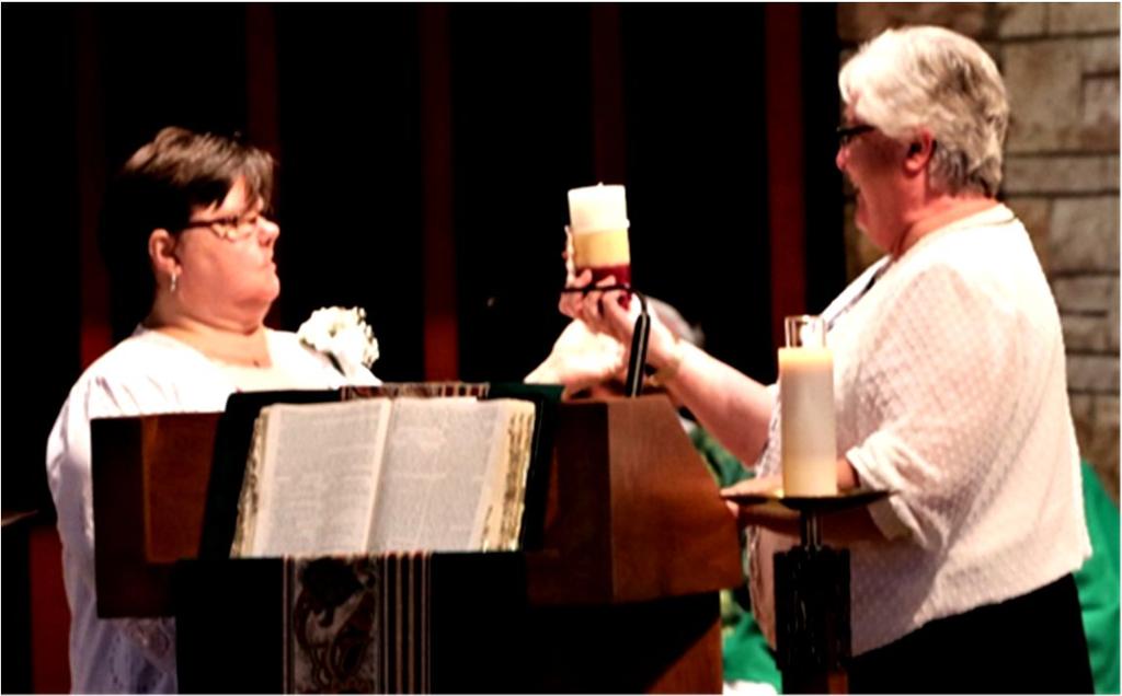 Margo St. Julien accepts her Jubilee candle from Sr.
