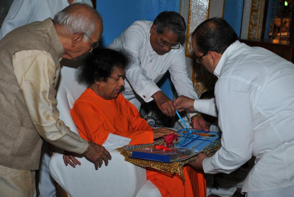 Bhagavan releases the Compendium of 45 years of Seva Across the Globe L-R: Sri Indulal Shah, the Founder and International Advisor, Sri Sathya Sai Organisations, Revered Bhagavan Sri Sathya Sai Baba,