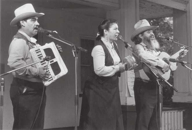158 Folklore in Utah Elisa y los Fronterisos perform at a Mondays in the Park concert in front of the Chase Home Museum of Utah Folk Arts, 1989.