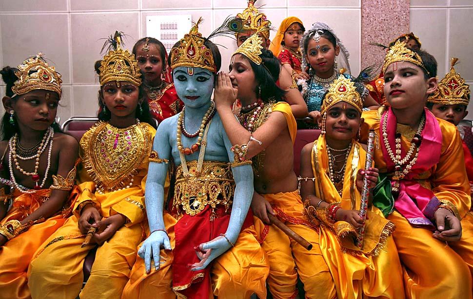 Children dressed as Lord Krishna wait for a fancy dress compe on.