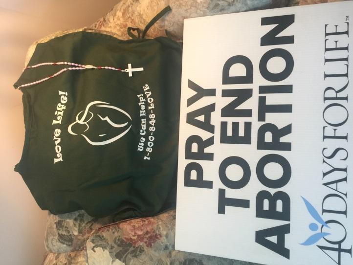 The message on the front of the apron gives pregnant parents a resource number to call and get help, and the