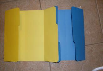 Take two of the folders and apply a generous amount of glue to their flaps. 6.