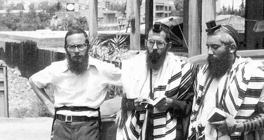 From right to left: Rabbi Raskin, Rabbi Popack, Rabbi Goldberg with the destruction of Beirut in the background THE TANYA FROM LEBANON GIVEN TO THE REBBE The night of the eve of Yom Kippur the men