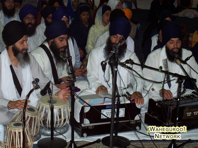 Sikh Prayer Service - Keertan Note the facial hair and the sling over the right shoulder of the men this sling carries the Kirpan.