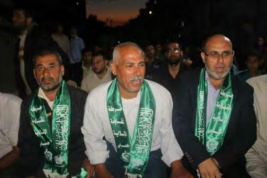 3 Right: Sayid Abu Salah (center), Saadi's father, at the memorial service
