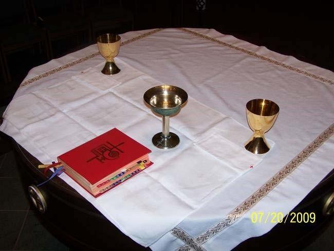 b) The Book Holder brings the book to the altar and places it at the far left of the altar, leaving room in the middle for the Corporal to be placed. Then return to your seat.