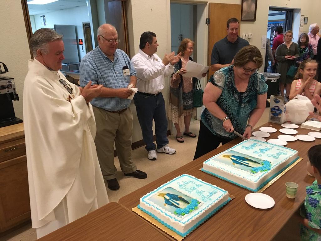Father Mike looked on as one of our parish Moms did the honors of making the first cut.